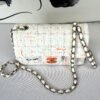 Chanel 24C White Tweed Mini Flap with Orange Enamel CC and Champagne Gold Hardware.